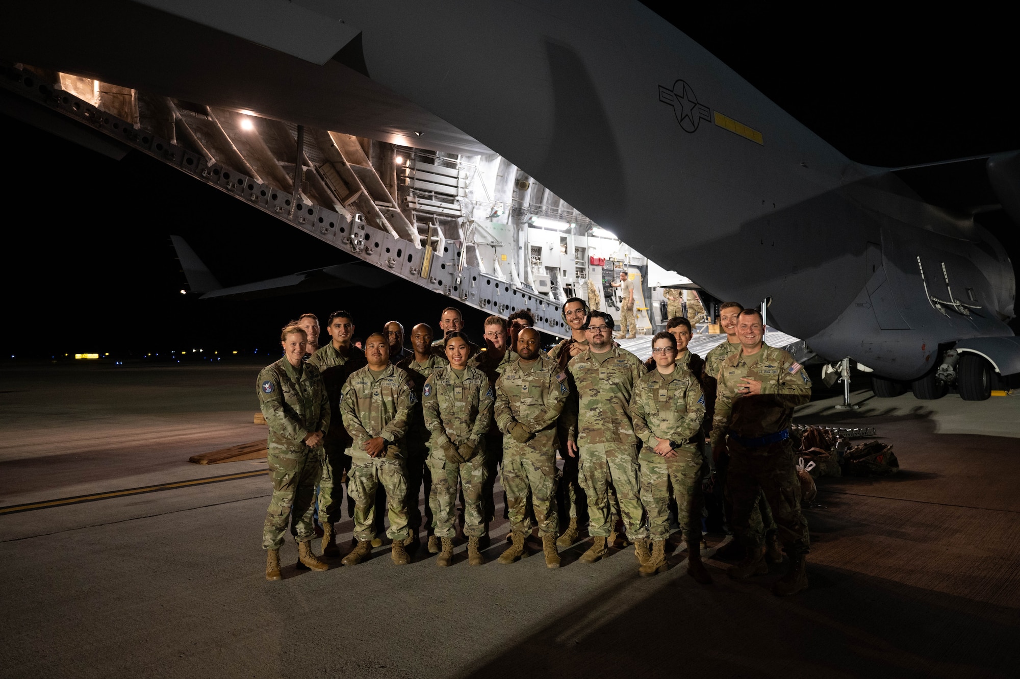 Personnel from the 4th Space Operations Squadron pose outside of a C-17 Globemaster III at Joint Base Pearl Harbor Hickam, Hawaii, Aug. 27, 2024. The team arrived as part of a contingency operations exercise to test a piece of communications equipment known as the Mobile Constellation Control Station. (U.S. Air Force photo by Technical Sgt. Tarelle Walker)