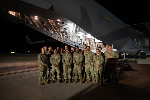  Personnel from the 4th Space Operations Squadron pose outside of a C-17 Globemaster III at Joint Base Pearl Harbor Hickam, Hawaii, Aug. 27, 2024. The team arrived as part of a contingency operations exercise to test a piece of communications equipment known as the Mobile Constellation Control Station. (U.S. Air Force photo by Technical Sgt. Tarelle Walker)