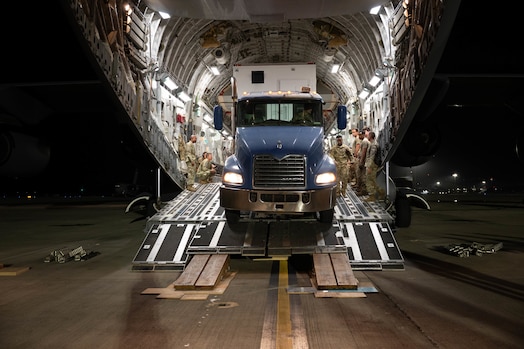 A truck backs up to offload cargo from a C-17 Globemaster III from Joint Base Lewis-McChord on the flightline at Joint Base Pearl Harbor Hickam, Hawaii, Aug. 27, 2024. The aircraft arrived carrying personnel and equipment necessary to carry out a contingency operations exercise meant to test the connectivity of a Mobile Constellation Control Station. (U.S. Air Force photo by Technical Sgt. Tarelle Walker)