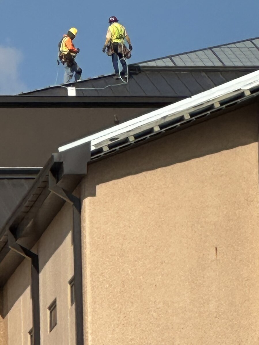 workers on the roof of the BMT building.
