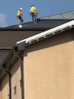 workers on the roof of the BMT building.