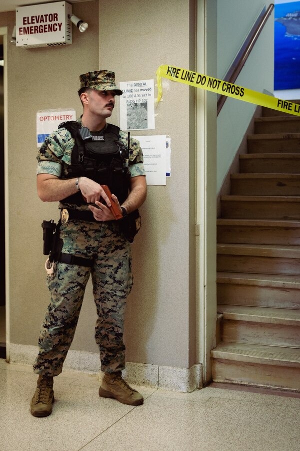 U.S. Marine Corps Sgt. Dillon Burns, a military police officer with the Provost Marshal’s Office (PMO), Headquarters and Support Battalion, stands guard during an emergency response drill on Marine Corps Base Camp Lejeune, North Carolina, Aug. 27, 2024.  The drill effectively demonstrated a joint interoperability capability between first responders, emergency managers and support personnel in the event of an emergency. (U.S. Marine Corps photo by Cpl. Yasmine De La Rosa)