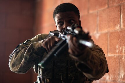 Airman holding training weapon