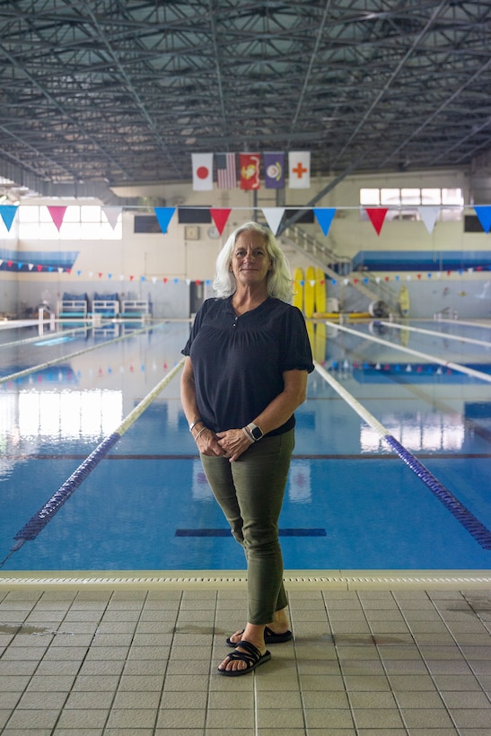 Jennifer Ayers, the Marine Corps Air Station Iwakuni aquatics director and a South Carolina native, poses for a portrait at the Marine Corps Community Services’ indoor pool on Sept. 5, 2024. Ayers and the MCAS Iwakuni aquatics team provide swim clinics and master classes, and train instructors with the goal to improve service members’ survival skills and increase their water confidence. (U.S. Marine Corps photo by Sgt. Phuchung Nguyen)