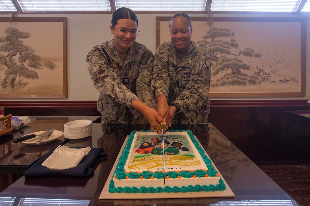 Master-at-Arms 3rd Class Iliana Armentia, assigned to Commander, Fleet Activities Yokosuka (CFAY), and Master Chief Culinary Specialist Temeka Rudd cut the cake during the Women’s Equality Day Open Galley event at the installation’s Commodore Matthew C. Perry General Mess, Aug. 29, 2024.