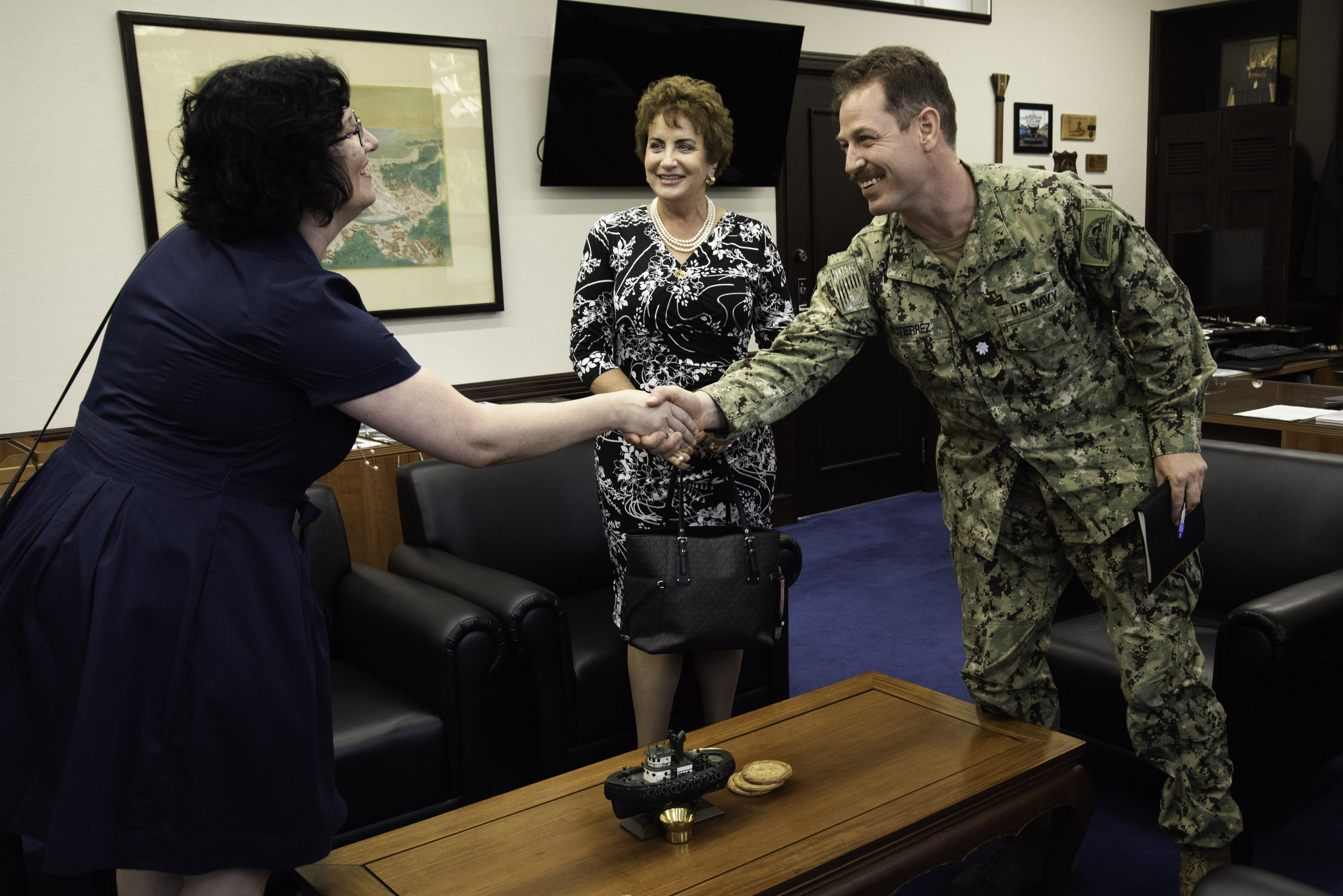 Cmdr. Patrick Gutierrez, Commander Fleet Activities Yokosuka (CFAY) chief staff officer, conducts an office call with Dr. Jacqueline Ferguson, Department of Defense Education Activity (DoDEA) Pacific East District Superintendent, left, and Ms. Lois J. Rapp, DoDEA Pacific Director for Student Excellence, middle, in CFAY Headquarters Building.