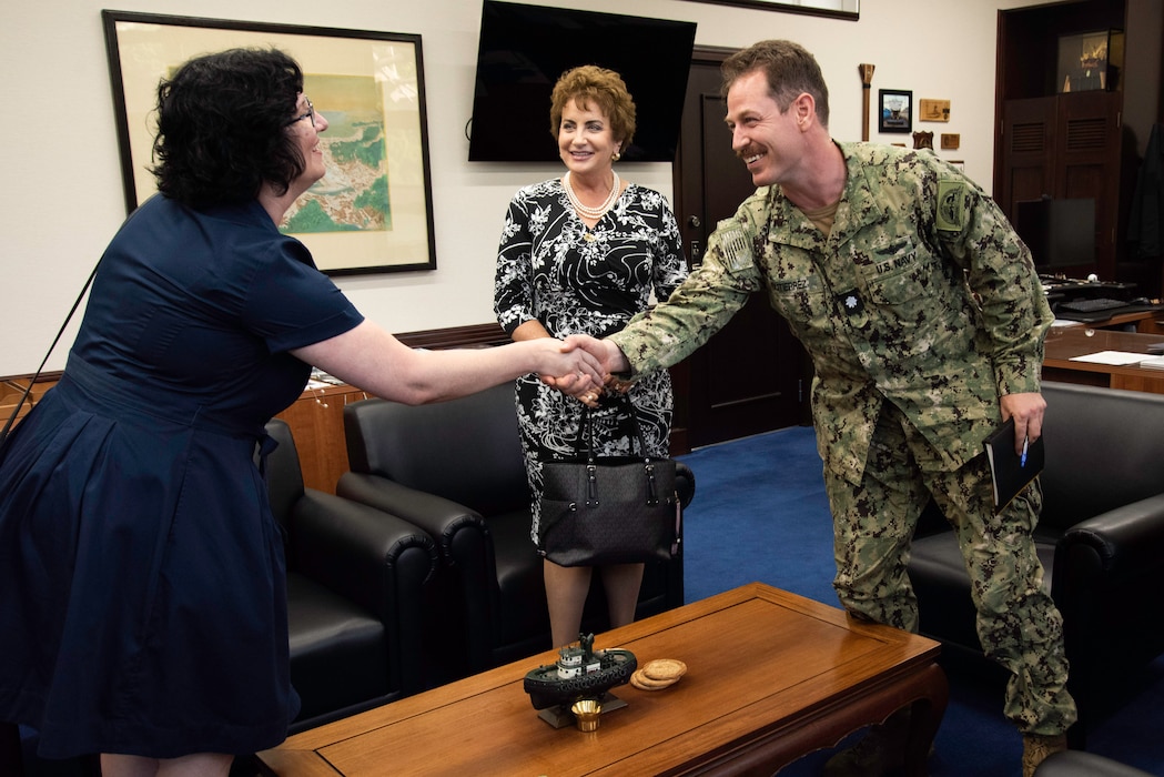 Cmdr. Patrick Gutierrez, Commander Fleet Activities Yokosuka (CFAY) chief staff officer, conducts an office call with Dr. Jacqueline Ferguson, Department of Defense Education Activity (DoDEA) Pacific East District Superintendent, left, and Ms. Lois J. Rapp, DoDEA Pacific Director for Student Excellence, middle, in CFAY Headquarters Building.