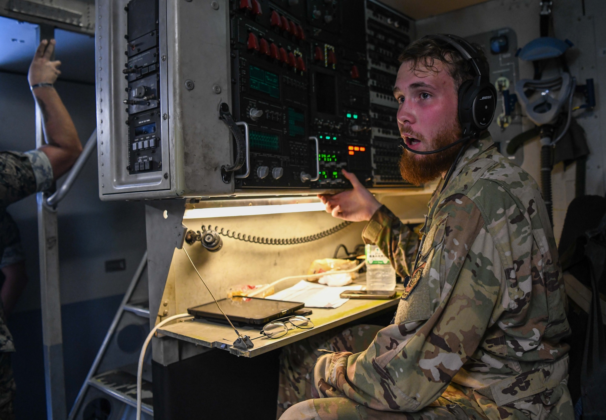 A U.S. Air Force loadmaster simulates a landing call.