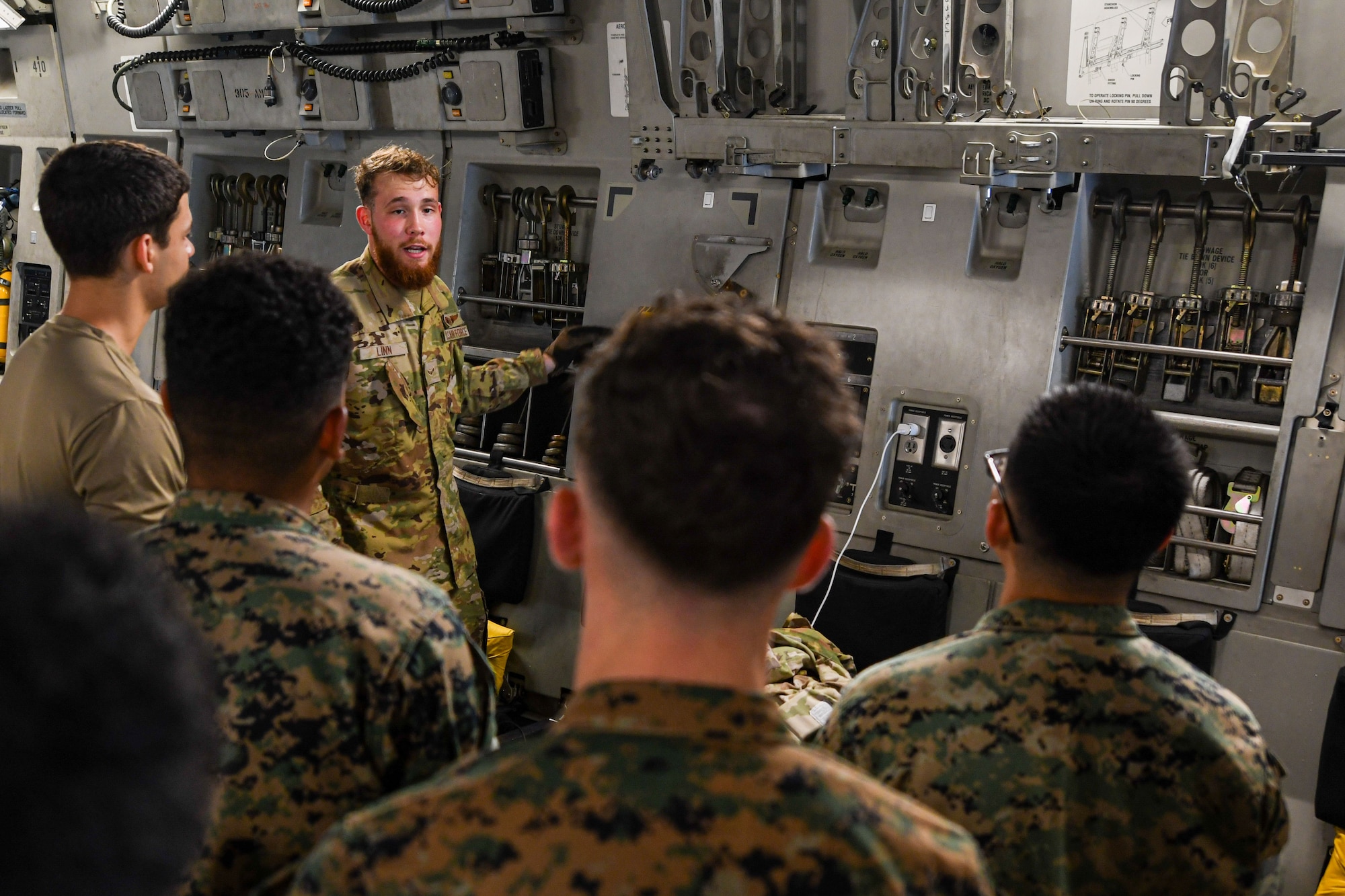 A loadmaster conducts an Orientation for Marines.