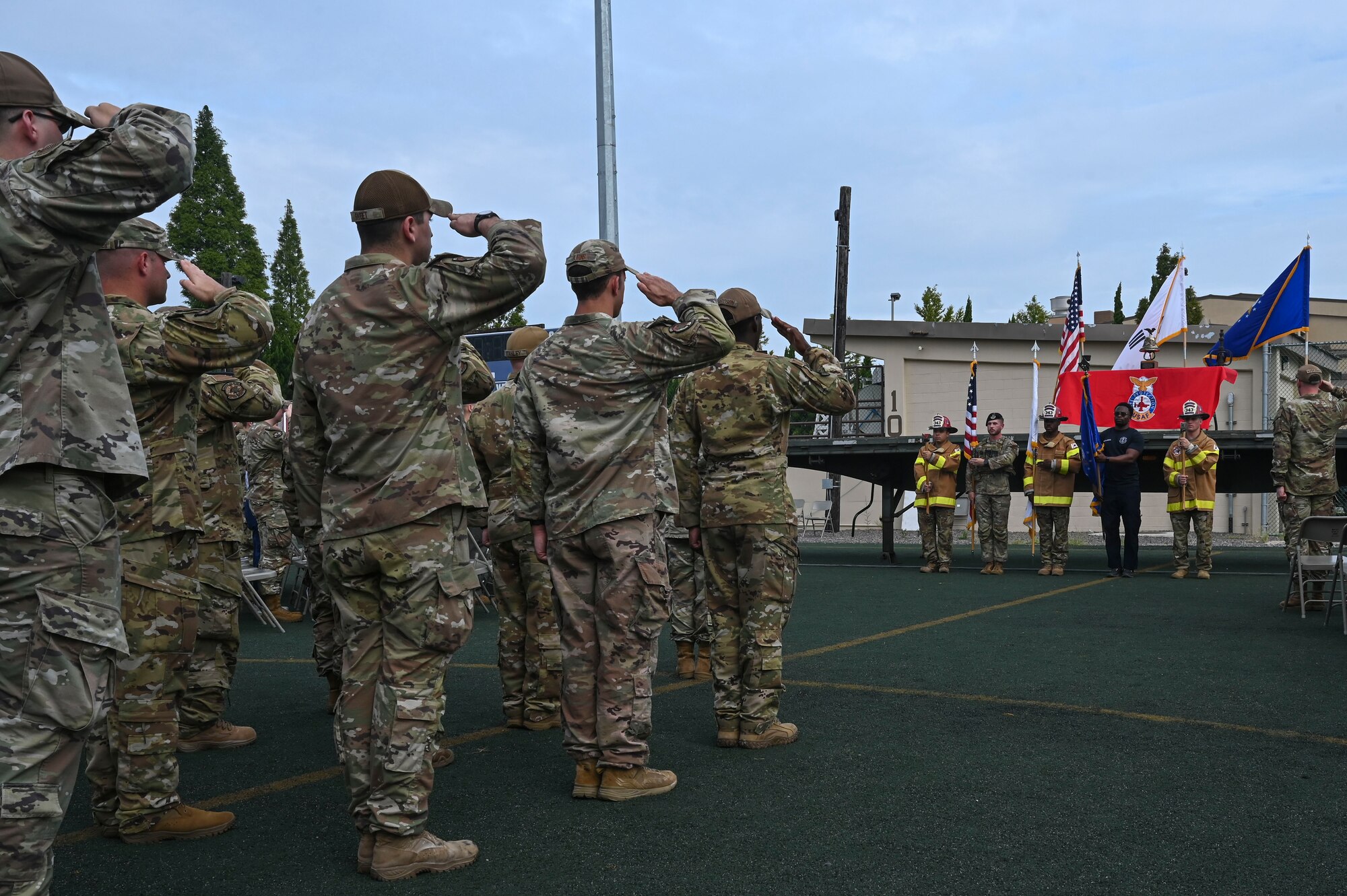 Airmen assigned to the 8th Fighter Wing salute during the playing of the Korean and U.S. national anthems for the 9/11 Remembrance Ceremony.