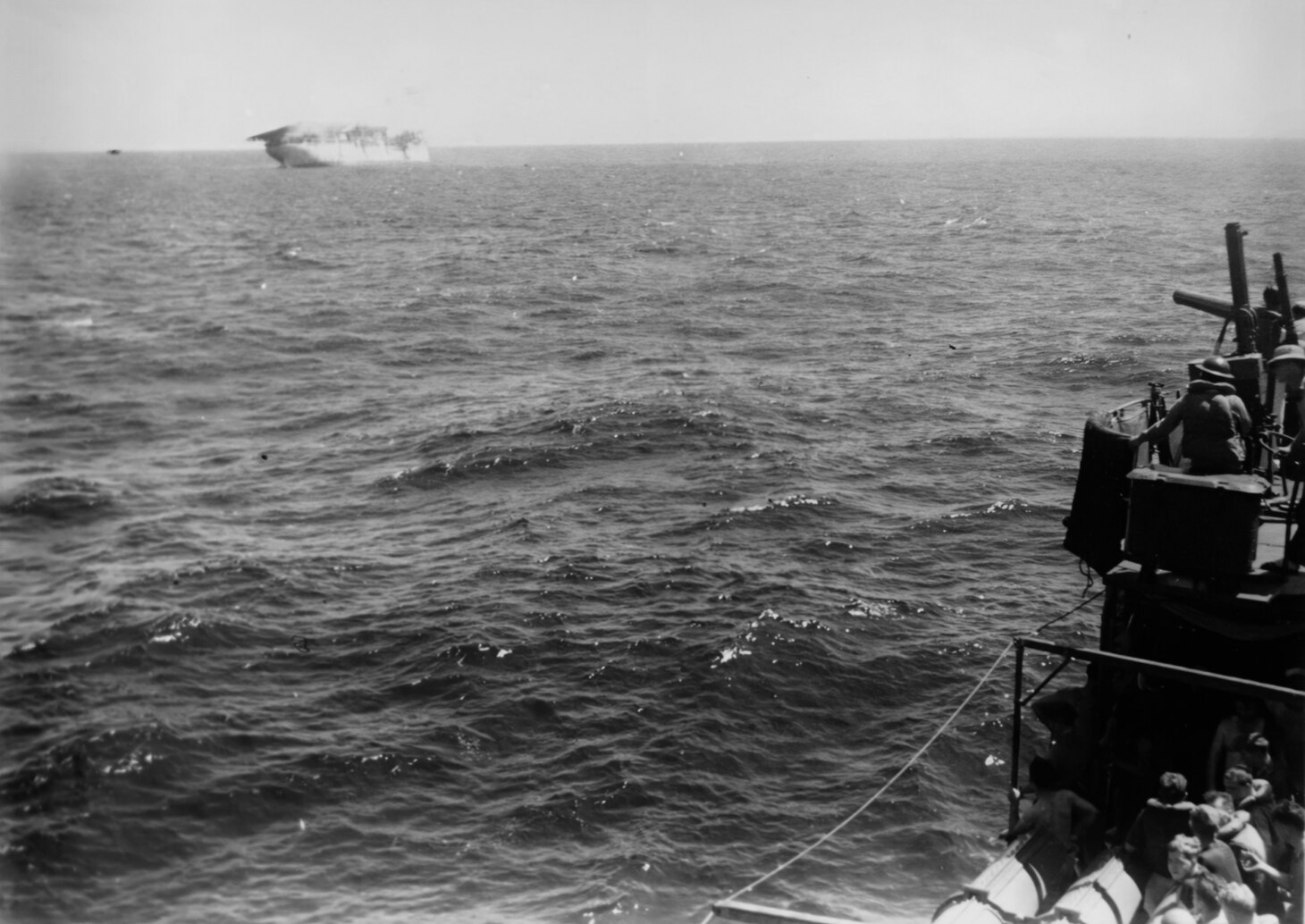 The Navy’s first carrier is shown sinking on Feb. 27, 1942, south of Java. The photo was taken from the destroyer USS Whipple (DD 217), which would soon deliver the final blows with guns and torpedoes after the Langley was hit by land-based Japanese G4M1 bombers.