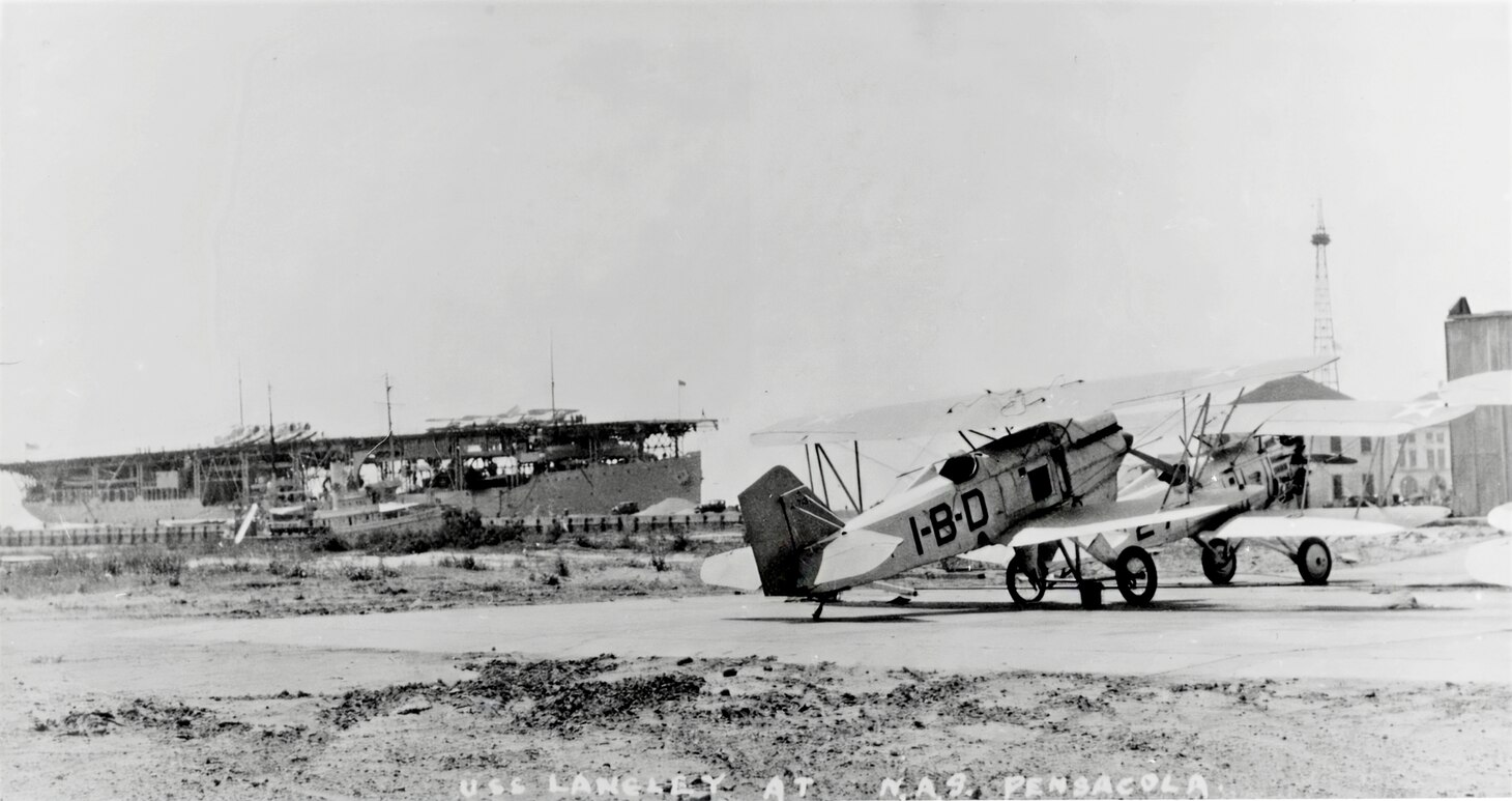 A rarely seen photo shows the Langley off Naval Air Station Pensacola, Florida, circa 1929. The aircraft in the foreground is a Curtiss F6C-3, which entered service in 1927 after the Langley had transferred to the Pacific Fleet. The aircraft’s fuselage markings are unusual in that they use letters rather than a combination of letters and numbers to indicate its squadron and position in the squadron, which is VB-1B, a carrier-based bomber squadron. Thus, IBD indicates this aircraft is the fourth in that unit. Although there has never been a satisfactory explanation for this odd designation system, it was probably developed to prevent any confusion between these aircraft and their new incoming F3B-1s. The first F3Bs began service with Fighting Sqaudron (VF) 2B in 1928, with the squadron soon reverting to its original designation of VF-6B. It was definitely a time of development and experimentation.