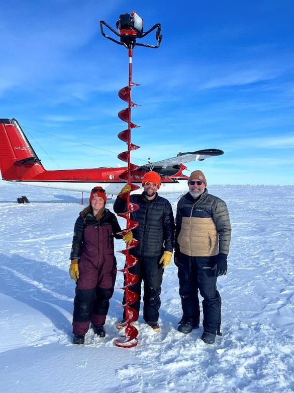 ERDC-CRREL scientists (from left to right) Tricia Nelsen, Dr. Chris Polashenski and Roy Hessner prepare for drilling through the Arctic sea ice to install an Ice Mast Balance Buoy.