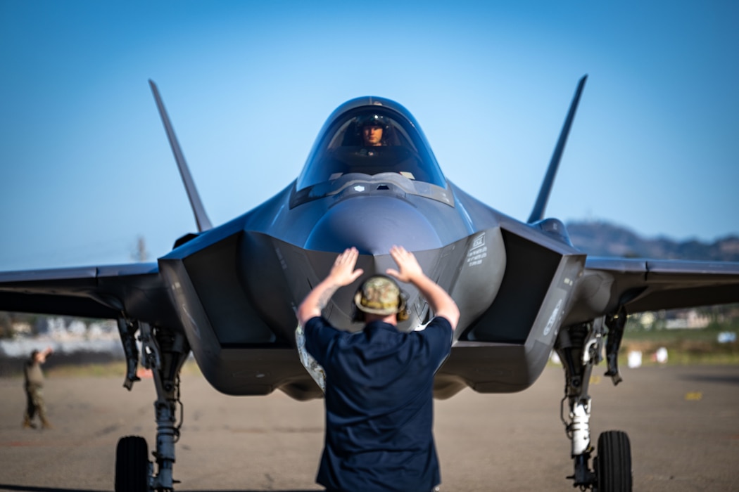 A U.S. Air Force crew chief assigned to the 34th Fighter Generation Squadron, marshals an F-35A Lightning II during exercise Agile Flag 24-3 in Santa Maria, California, Aug. 5, 2024. The exercise provided Airmen with realistic conflict training, preparing the Wing for future deployments and equipping leaders to make rapid decisions and mission orders to succeed against peer adversaries. (U.S. Air Force photo by 2nd Lt. Benjamin Williams)