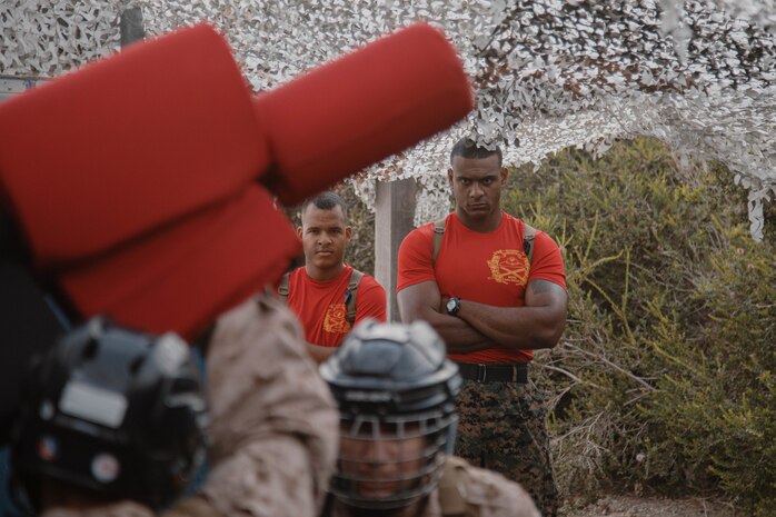 U.S. Marine Corps Sgt. Manuel De La Rosa, a drill instructor with Bravo Company, 1st Recruit Training Battalion, observes a pugil stick event at Marine Corps Recruit Depot San Diego, California, Aug. 27, 2024.  Recruits are taught Marine Corps Martial Arts Program techniques which instill basic self-defense that they will execute throughout recruit training to help build a warrior ethos and esprit de corps. (U.S. Marine Corps photo by Cpl. Elliott A. Flood-Johnson)