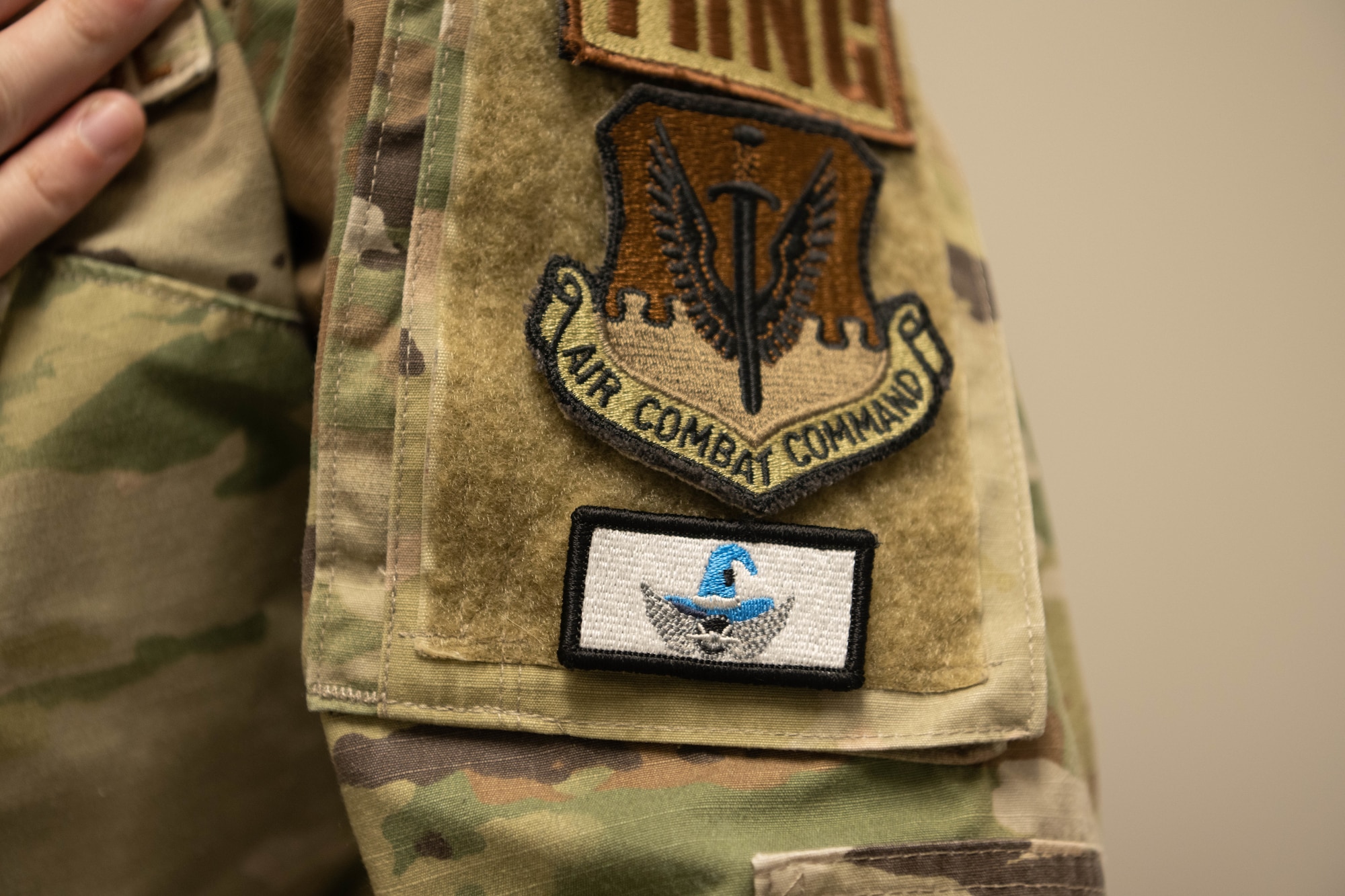 A photo of a white uniform patch with blue wings