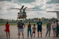 Friends and family members of Chief Warrant Officer 4 Richard “Trey” McCormick of Springfield, Illinois, serving with Detachment 5, A Company, 2nd Battalion 245th Aviation Regiment based in Springfield, Illinois, watch as he lands a Boeing CH-47 Chinook Helicopter at the Abraham Lincoln Capital Airport in Springfield, Illinois on Sept. 6.