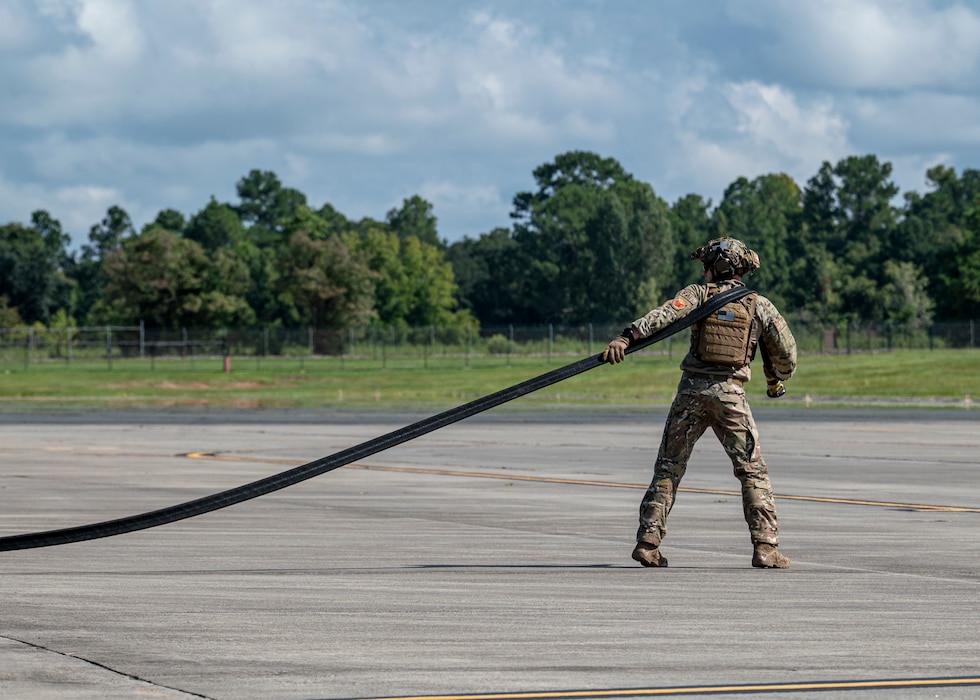 A U.S. Air Force Airman assigned to the 23rd Logistics Readiness Squadron drags a refueling hose at Moody Air Force Base, Georgia, Aug. 28, 2024. Forward Area Refueling Point Airmen are able to rapidly refuel and rearm aircraft in austere locations in support of Agile Combat Employment concepts. (U.S. Air Force photo by Senior Airman Leonid Soubbotine)