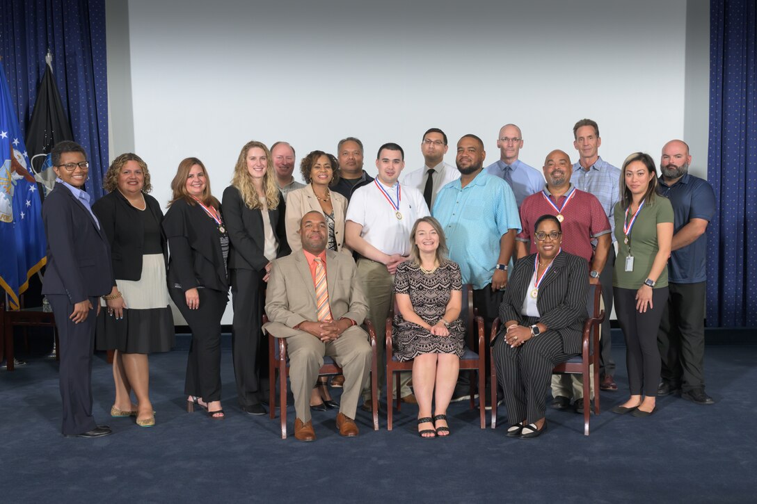 Participants in the Defense Logistics Agency Energy’s Contracting Officer Mentoring Program pose for a group photo after the closing ceremony .