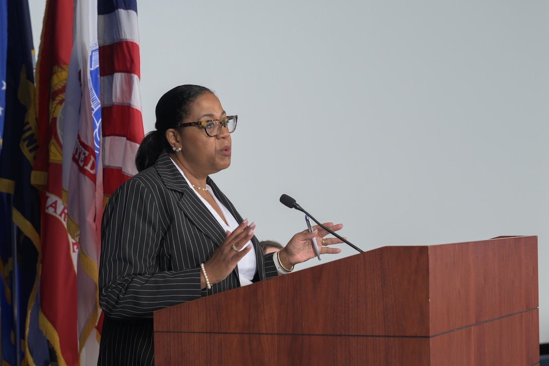 Defense Logistics Agency Energy commander speaks to employees about upcoming events.