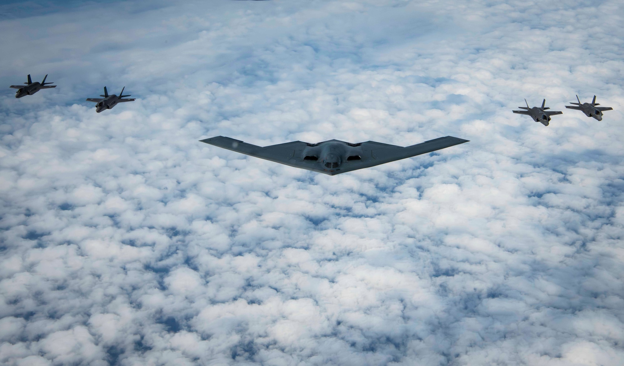 A U.S. Air Force B-2 Spirit stealth bomber and four Japan Air Self-Defense Force F-35A Lightning IIs, fly in formation over the Indo-Pacific area of responsibility, Sept. 10, 2024. Bomber missions provide opportunities to train and work with our Allies and partners in joint and coalition operations and exercises. (U.S. Air Force photo by Senior Airman Samantha White)
