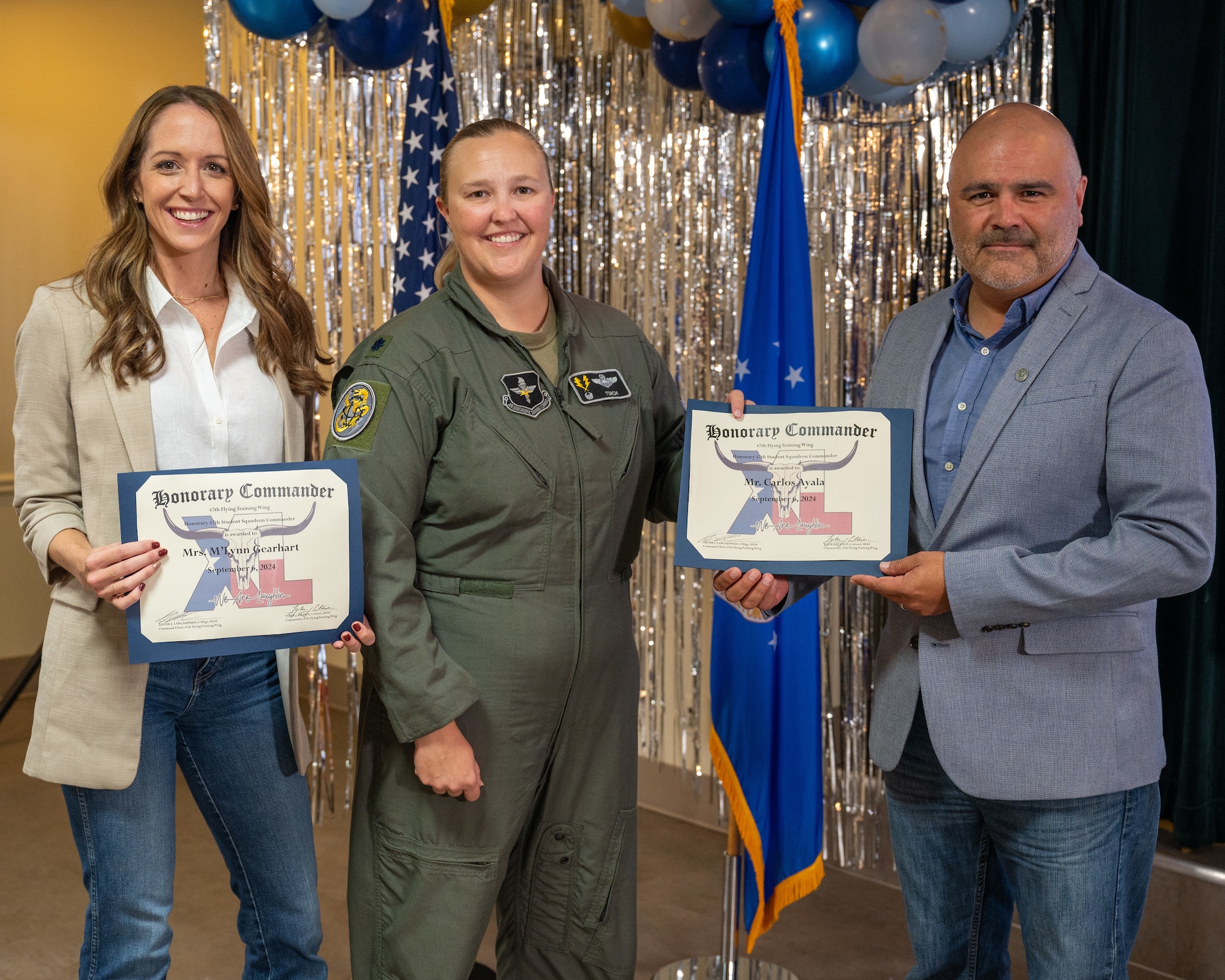 An honorary commander accepts their certificate from their commander at the honorary commander induction ceremony at Laughlin Air Force Base, Texas, Sept. 6, 2024. The honorary commander program looks to bring local community leaders and base personnel closer together, fostering the close relationship between Del Rio and Laughlin. (U.S. Air Force photo by Staff Sgt. Nicholas Larsen)