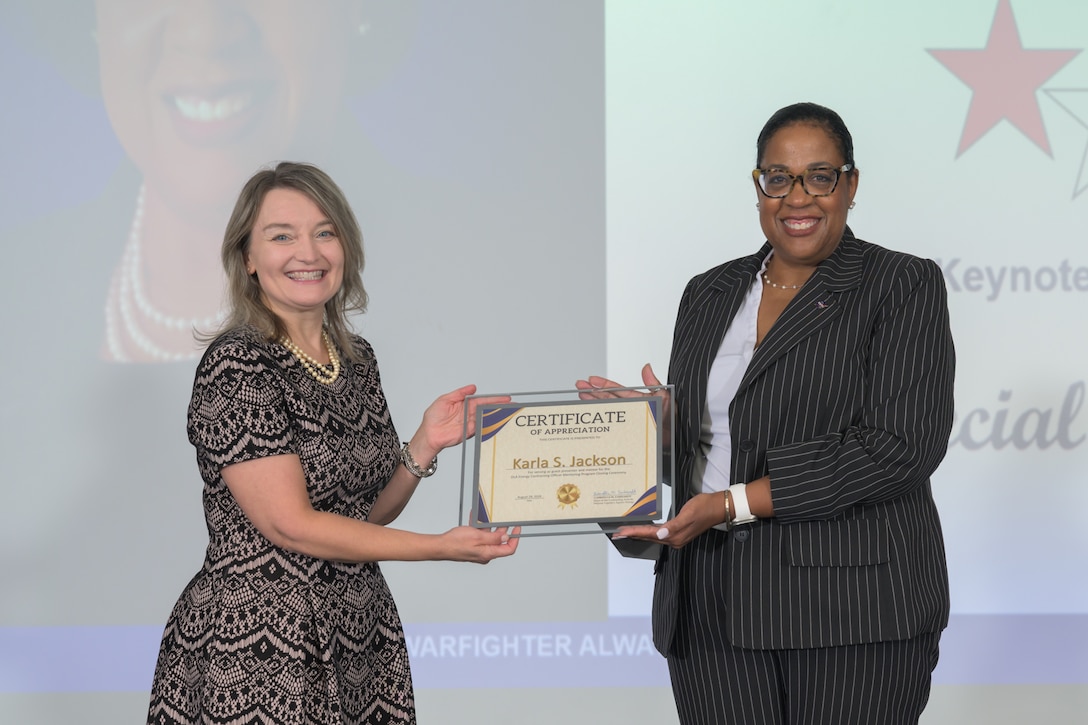 Two women pose for a picture after award was presented.