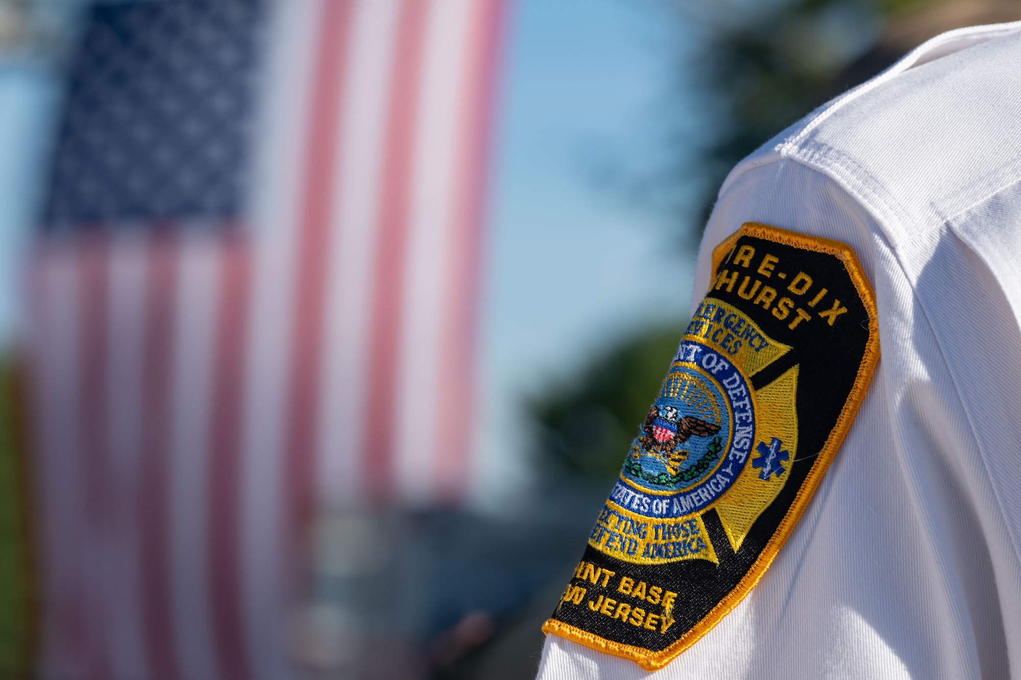 A Joint Base McGuire-Dix-Lakehurst emergency services member patch is displayed during a 9/11 remembrance ceremony at JB MDL, N.J., Sept. 11, 2024. The annual ceremony honors the nearly three thousand lives lost to the terrorist attacks that took place on September 11, 2001. (U.S. Air Force photo by Aidan Thompson)
