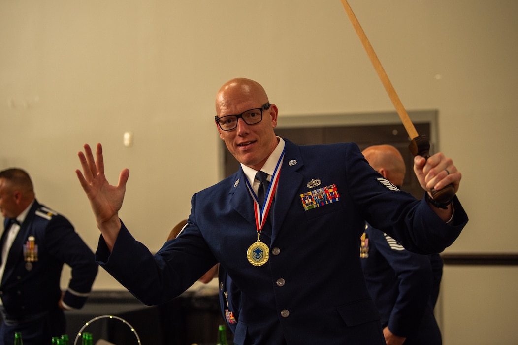 U.S. Air Force Master Sgt. Troy T. Debolt, 71st Rescue Generation Squadron senior noncommissioned officer, celebrates his new title at a senior noncommissioned officer induction ceremony, Valdosta State University Ballroom, Valdosta, Georgia, Sept. 05, 2024. The Sword given to each inductee is a symbol of the hard work it took to achieve the rank of Master Sgt. (U.S. Air Force photo by Airman 1st Class Iain Stanley)