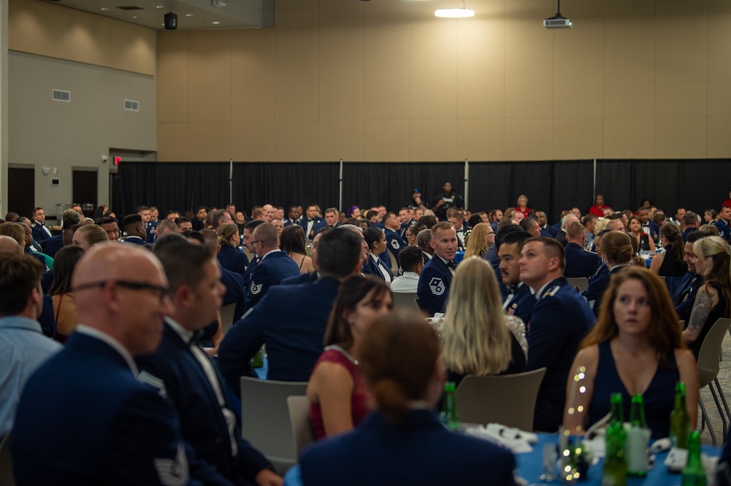 U.S. Air Force Airmen and their families mingle during a senior noncommissioned officer induction ceremony at the Valdosta State University Ballroom, Valdosta, Georgia, Sept. 05, 2024. This monumental event offered families of the inductees the chance to celebrate their loved ones' accomplishment around friends. (U.S. Air Force photo by Airman 1st Class Iain Stanley)