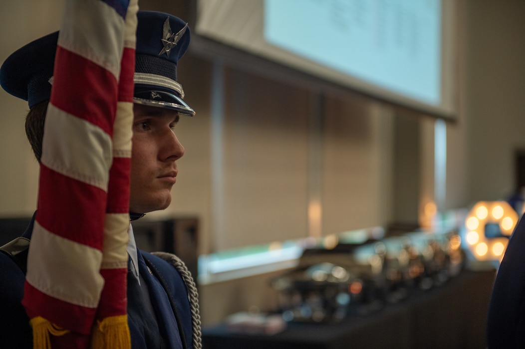 A U.S. Air Force Airman assigned to the 23rd Force Support Squadron honor guard, prepares to present the colors for the National Anthem at the Valdosta State University Ballroom, Valdosta, Georgia, Sept. 05, 2024. The inductees have demonstrated strength and perseverance, and the U.S. Air Force has placed its trust in these experienced and skilled leaders, advancing them to the next level of their careers. (U.S. Air Force photo by Airman 1st Class Iain Stanley)