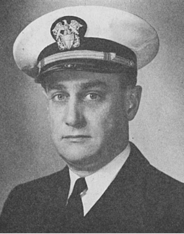 A man in uniform and cap poses for a photo.