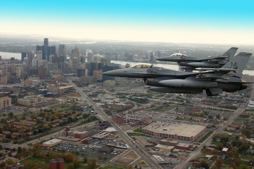 Two F-16s Fighting Falcons, from the 107th Fighter Squadron, Michigan Air National Guard, fly an alert soverignty mission over Detroit, Oct. 28, 2002. On 9/11, the same mission patrolled the Detroit region in the wake of the terrorist attacks on the United States. (U.S. Air National Guard photo by John Swanson)