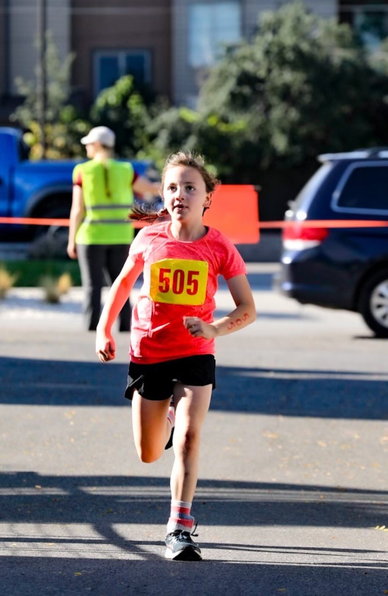 A young girl runs on a running course