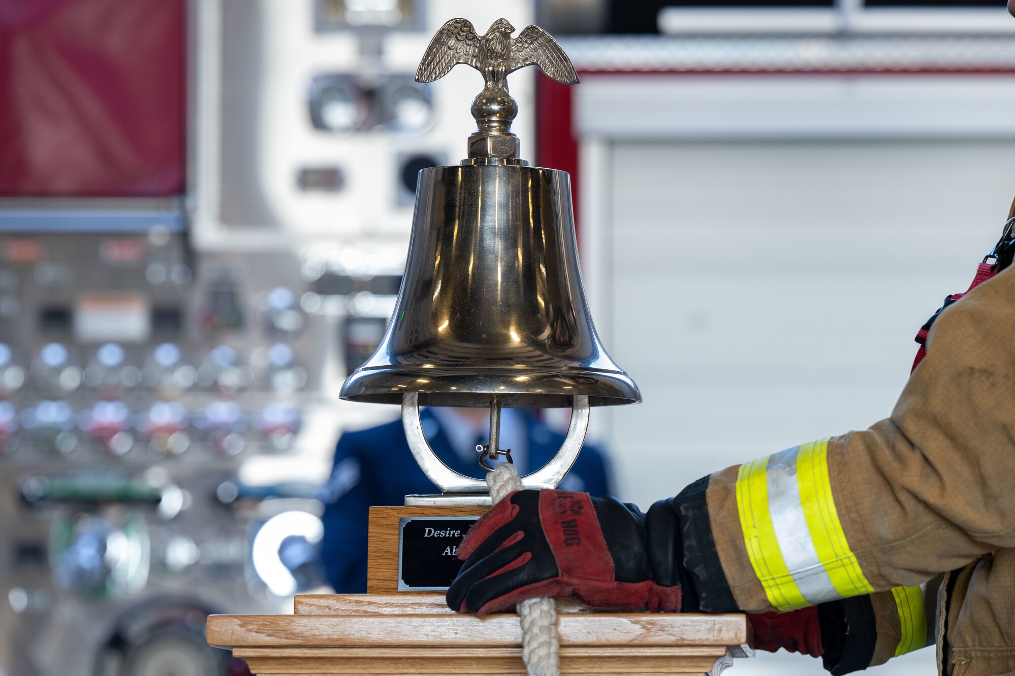 A fireman from the 22nd Civil Engineer Squadron Fire Department rings the bell during the Patriot Day Ceremony at McConnell Air Force Base, Kansas, Sept. 11, 2024. The ceremony was held to honor the lives lost in the wake of the tragic events that happened on Sept. 11, 2001. (U.S. Air Force photo by Senior Airman Felicia Przydzial)