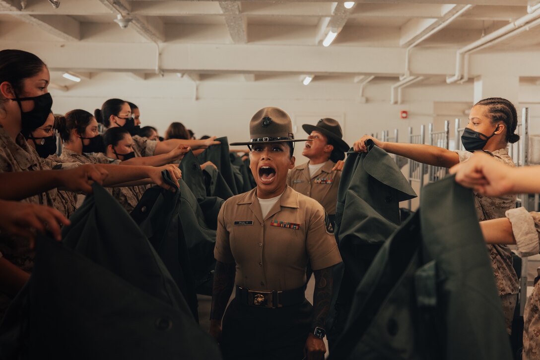 U.S. Marine Corps Staff Sgt. Mary Phaly, a drill instructor with Golf Company, 2nd Recruit Training Battalion, gives instructions to new recruits on pick up day, at Marine Corps Recruit Depot San Diego, California, Sep. 7, 2024. Pick up day signifies the first day of training in which recruits meet their drill instructor team for the first time, prepare their gear and squad-bay, and expectations are set for the remainder of their time in recruit training. (U.S. Marine Corps photo by Cpl. Alexander O. Devereux)
