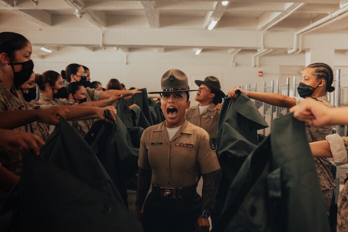U.S. Marine Corps Staff Sgt. Mary Phaly, a drill instructor with Golf Company, 2nd Recruit Training Battalion, gives instructions to new recruits on pick up day, at Marine Corps Recruit Depot San Diego, California, Sep. 7, 2024. Pick up day signifies the first day of training in which recruits meet their drill instructor team for the first time, prepare their gear and squad-bay, and expectations are set for the remainder of their time in recruit training. (U.S. Marine Corps photo by Cpl. Alexander O. Devereux)