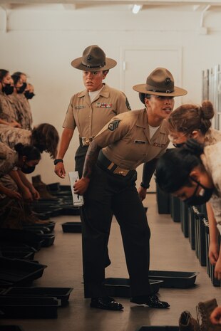 U.S. Marine Corps Staff Sgt. Mary Phaly, a drill instructor with Golf Company, 2nd Recruit Training Battalion, gives instructions to new recruits on pick up day, at Marine Corps Recruit Depot San Diego, California, Sep. 7, 2024. Pick up day signifies the first day of training in which recruits meet their drill instructor team for the first time, prepare their gear and squad-bay, and expectations are set for the remainder of their time in recruit training. (U.S. Marine Corps photo by Cpl. Alexander O. Devereux)