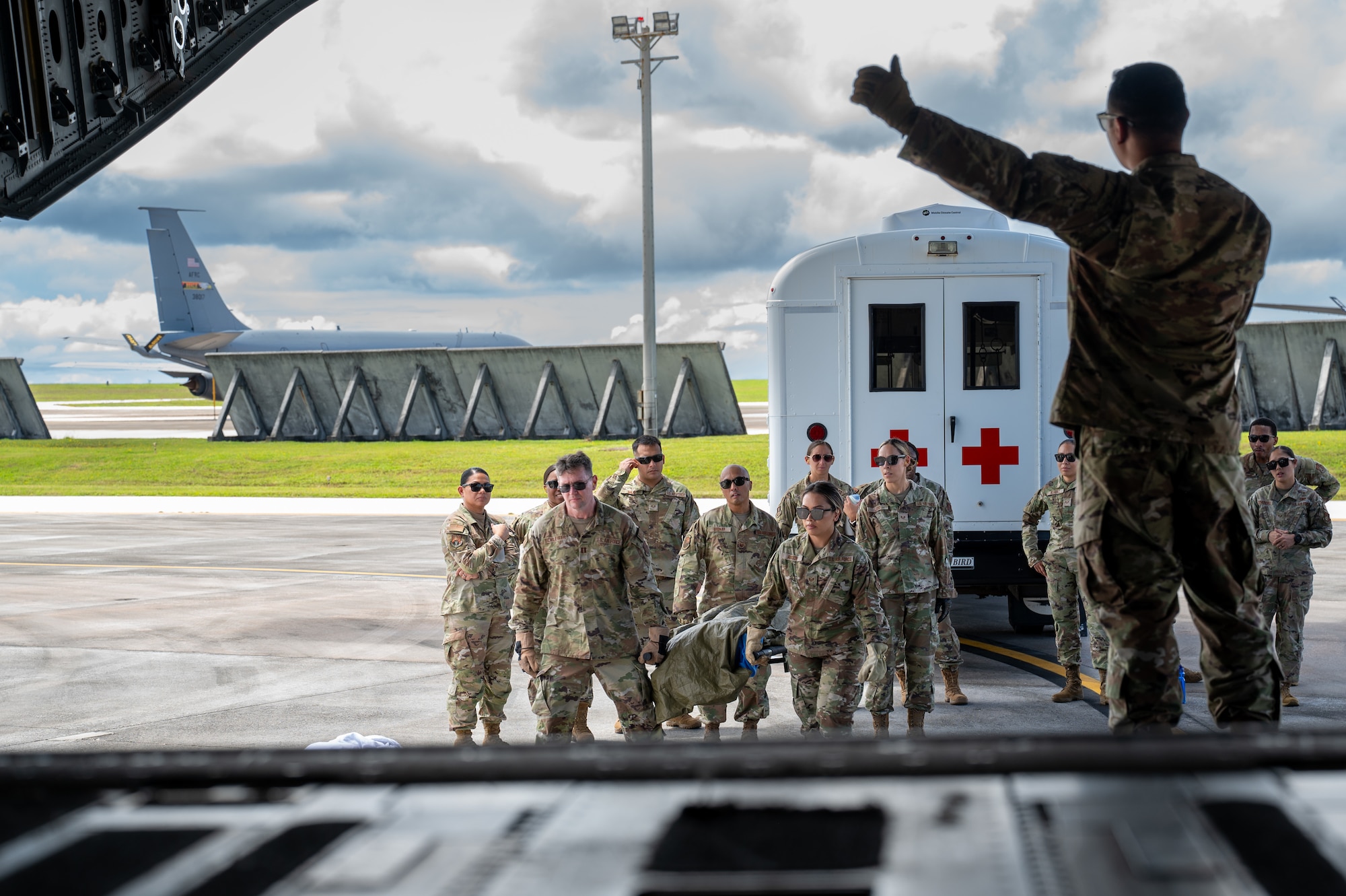 U.S. Air Force Capt. Robin Alarcon, 36th Medical Readiness Flight commander communicates to a litter team during aeromedical evacuation training on Andersen Air Force Base, Guam, Sep. 6, 2024. This training helps support rapid global mobility by being prepared to respond to humanitarian or wartime requests assisting with preserving and safeguarding lives. (U.S. Air Force photo by Airman 1st Class Manasseh Demissie)