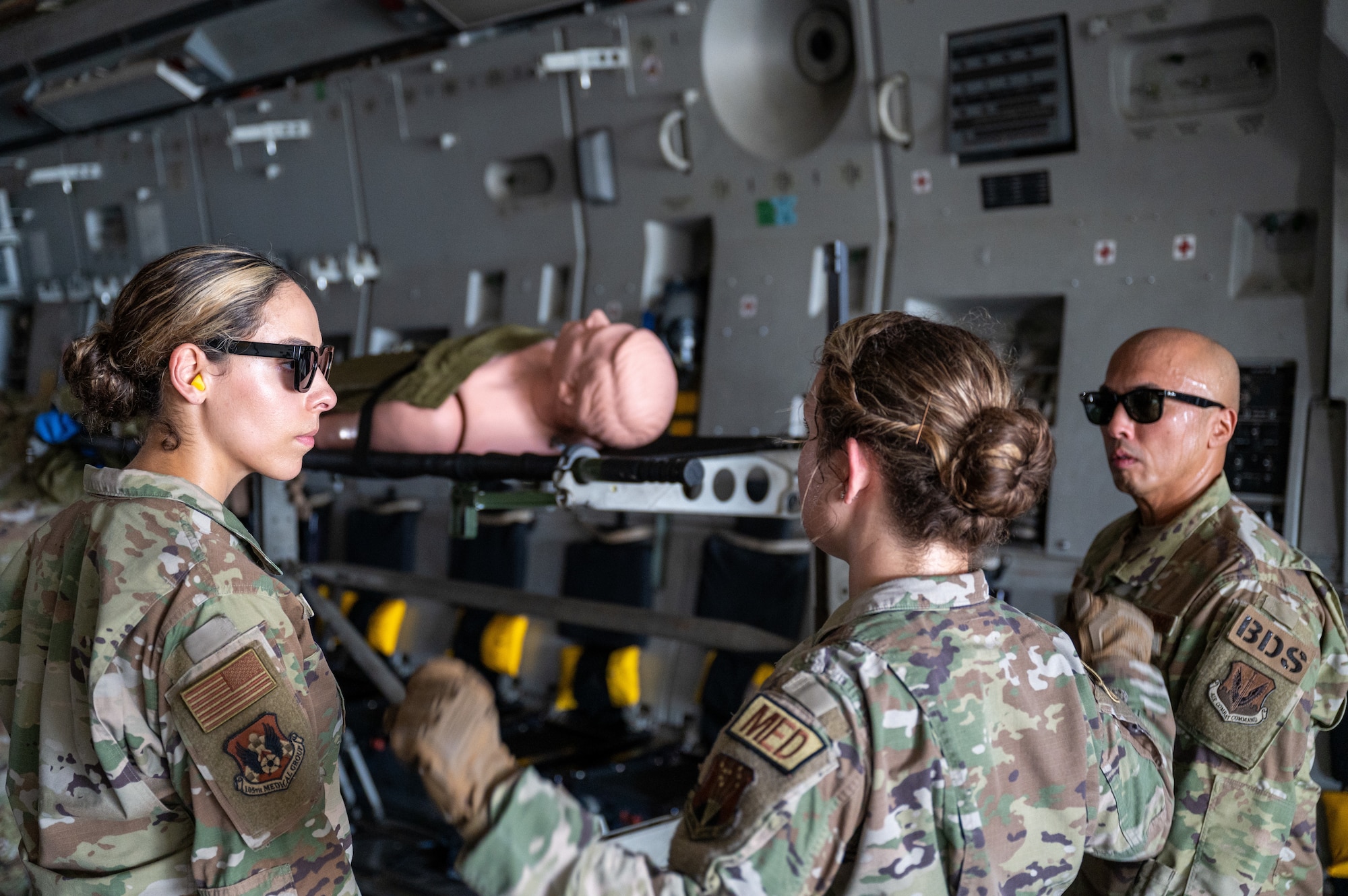 U.S. Air Force 1st Lt. Courtney Kalb, 624th Aerospace Medicine Flight, Clinical Nurse gives instructions on how members should load simulated patients onto stantions on Andersen Air Force Base, Guam, Sep. 06, 2024. The training provided 36th MDG Airmen with hands-on training of airlift and aeromedical evacuation tactics. (U.S. Air Force photo by Airman 1st Class Manasseh Demissie)