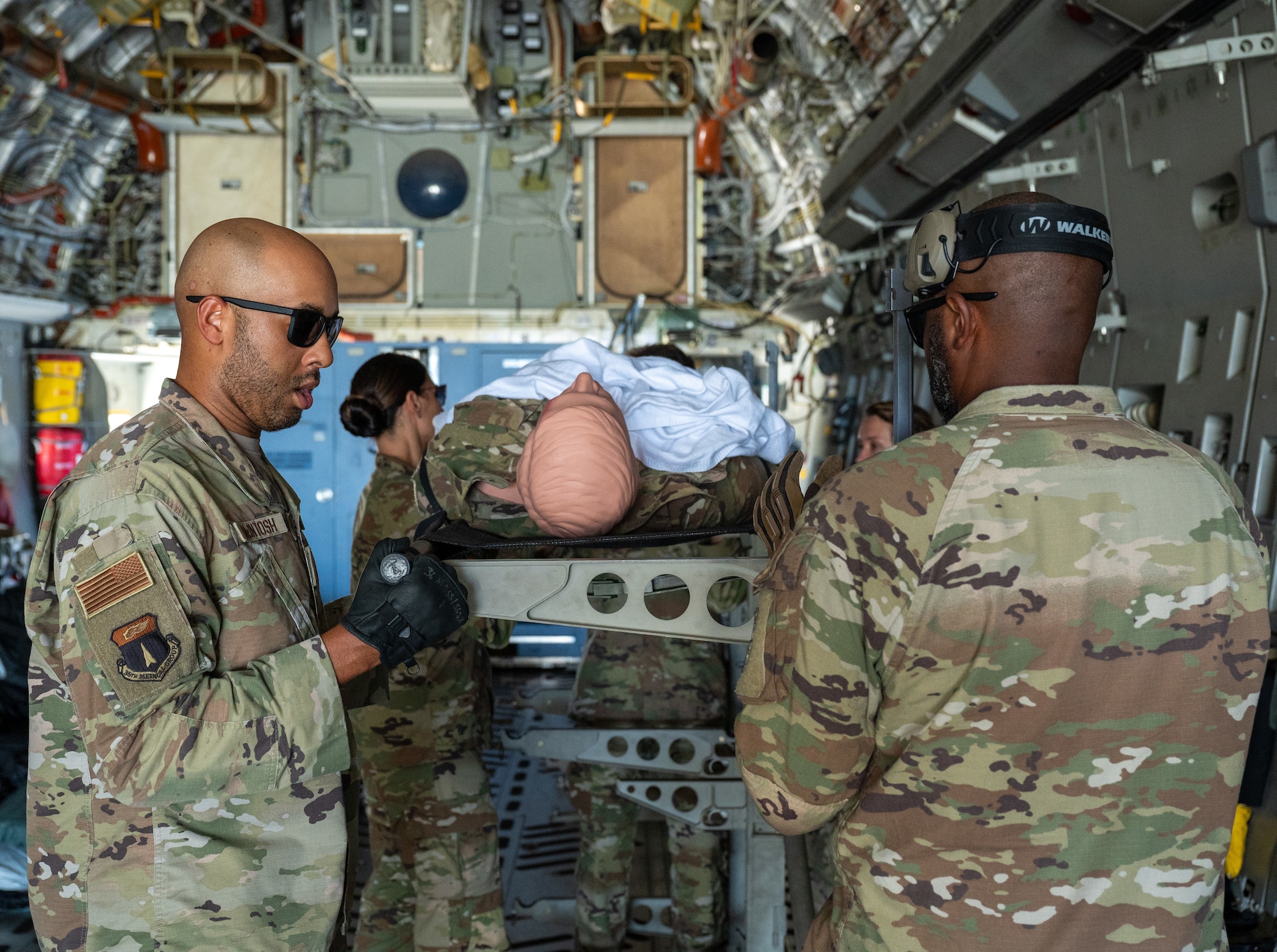 U.S. Air Force Airmen from the 36th Medical Group secure the litter of a simulated patient to the stantion of the C17 Globemaster III from the 437th Airlift Wing Joint Base Charleston, South Carolina, on Andersen Air Force Base, Guam, Sep. 06, 2024. The training provided 36th MDG Airmen with hands-on training of airlift and aeromedical evacuation tactics. (U.S. Air Force photo by Airman 1st Class Manasseh Demissie)