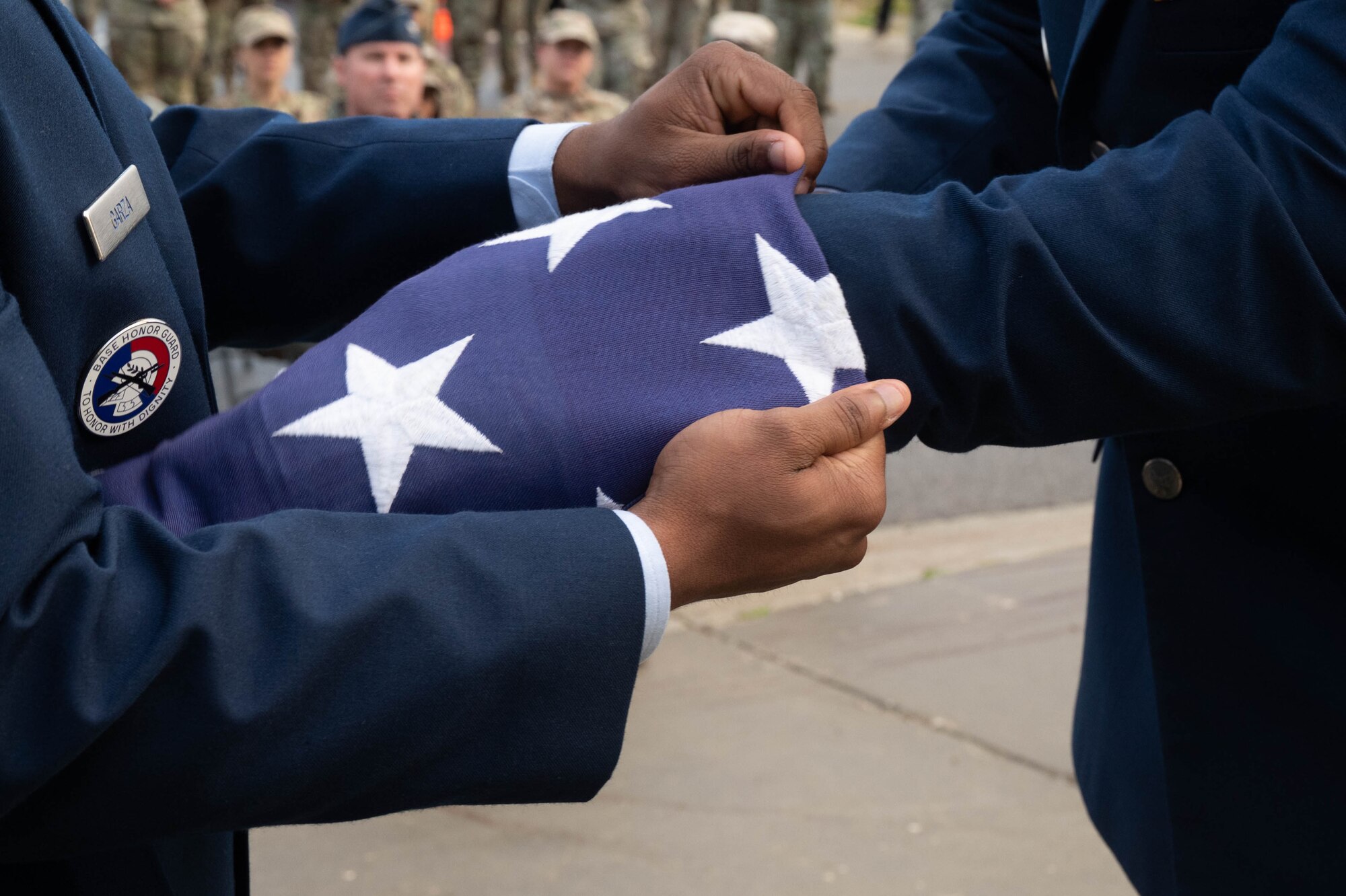 U.S. Air Force Airman 1st Class Tyler Edmundson, right, and Patrick Garza, 354th Security Forces Squadron entry controllers, fold an American flag during a 9/11 remembrance ceremony at Eielson Air Force Base, Alaska, Sept. 11, 2024.