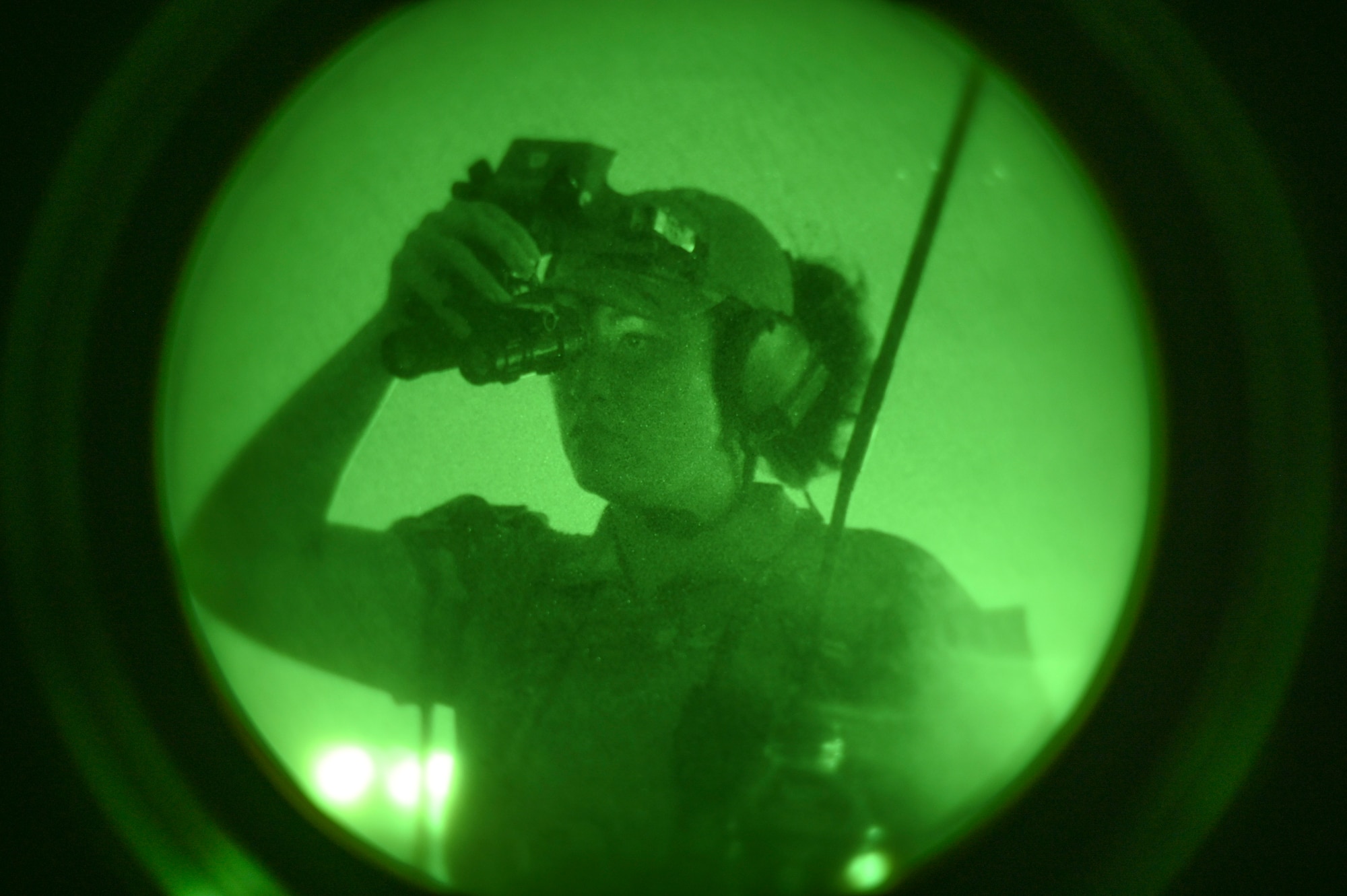 U.S. Air Force Tech. Sgt. Kathy Sells, 8th Operational Support Squadron noncommissioned officer in charge of airfield management operations, looks through night vision goggles during helicopter landing zone operations at Kunsan Air Base, Republic of Korea.