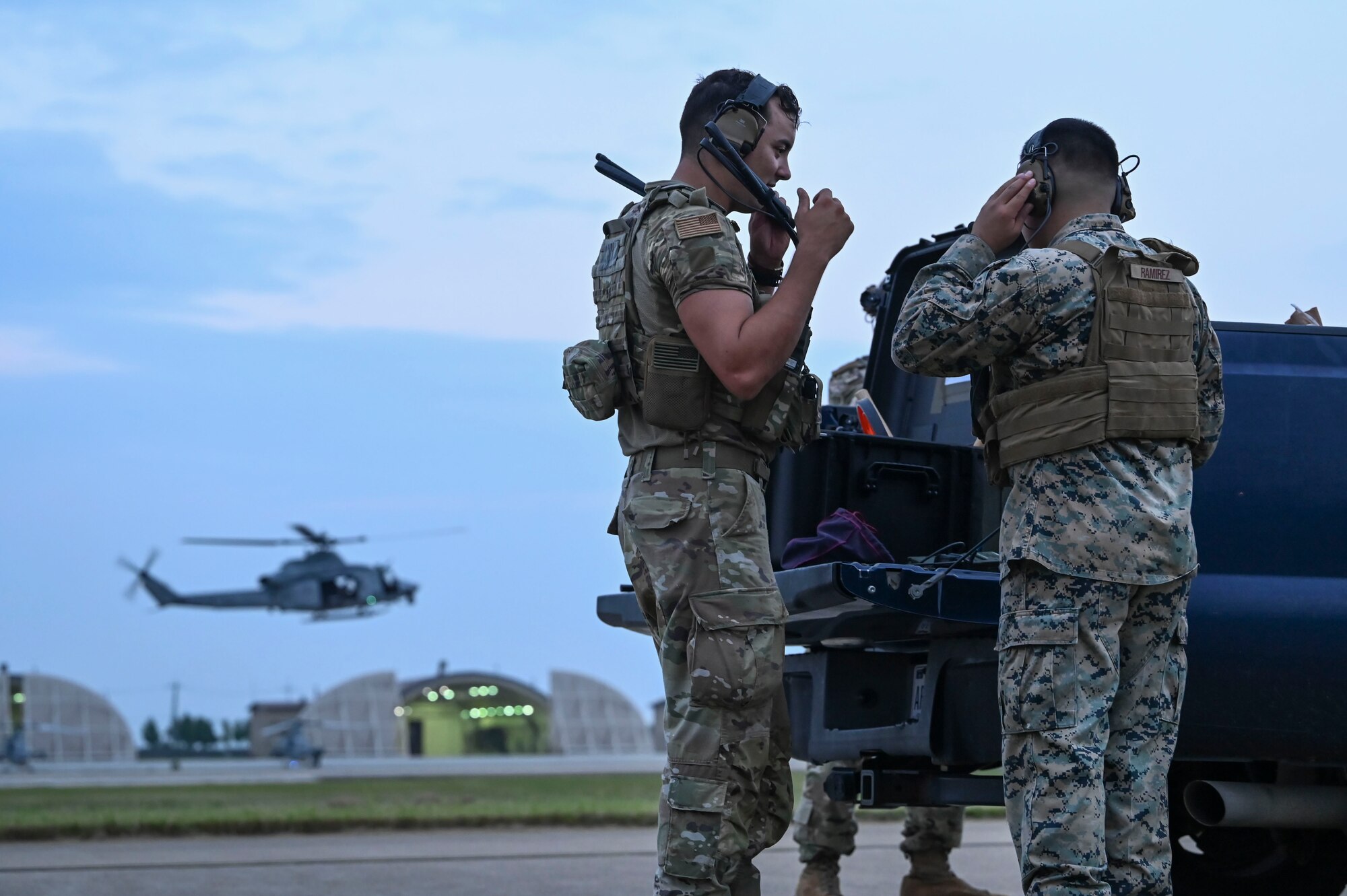 U.S. Air Force Tech Sgt. Tyler Twilley, left, 8th Operations Support Squadron radar approach control, and U.S. Marine Corps Sgt. Alex Ramirez, 8th OSS air traffic controller, prepare gear for airfield operations at Kunsan Air Base, Republic of Korea.