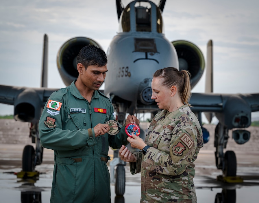 U.S. Air Force Master Sgt. Stephanie Krohn Todaro, 25th Fighter Generation Squadron first sergeant, exchanges patches with Corporal Arya Navratan, Indian Air Force 32nd Wing, maintenance technician, at Jodhpur Air Force Station, Rajasthan, India, Aug. 31, 2024. The U.S. -India are working together to advance a vision of a free and open Indo-Pacific where trade and ideas exchange freely. Through exercises and engagements, the U.S. improves it’s ability to work together with allies and partners, building upon our collective strength. (U.S. Air Force photo by Senior Airman Sabrina Fuller-Judd)