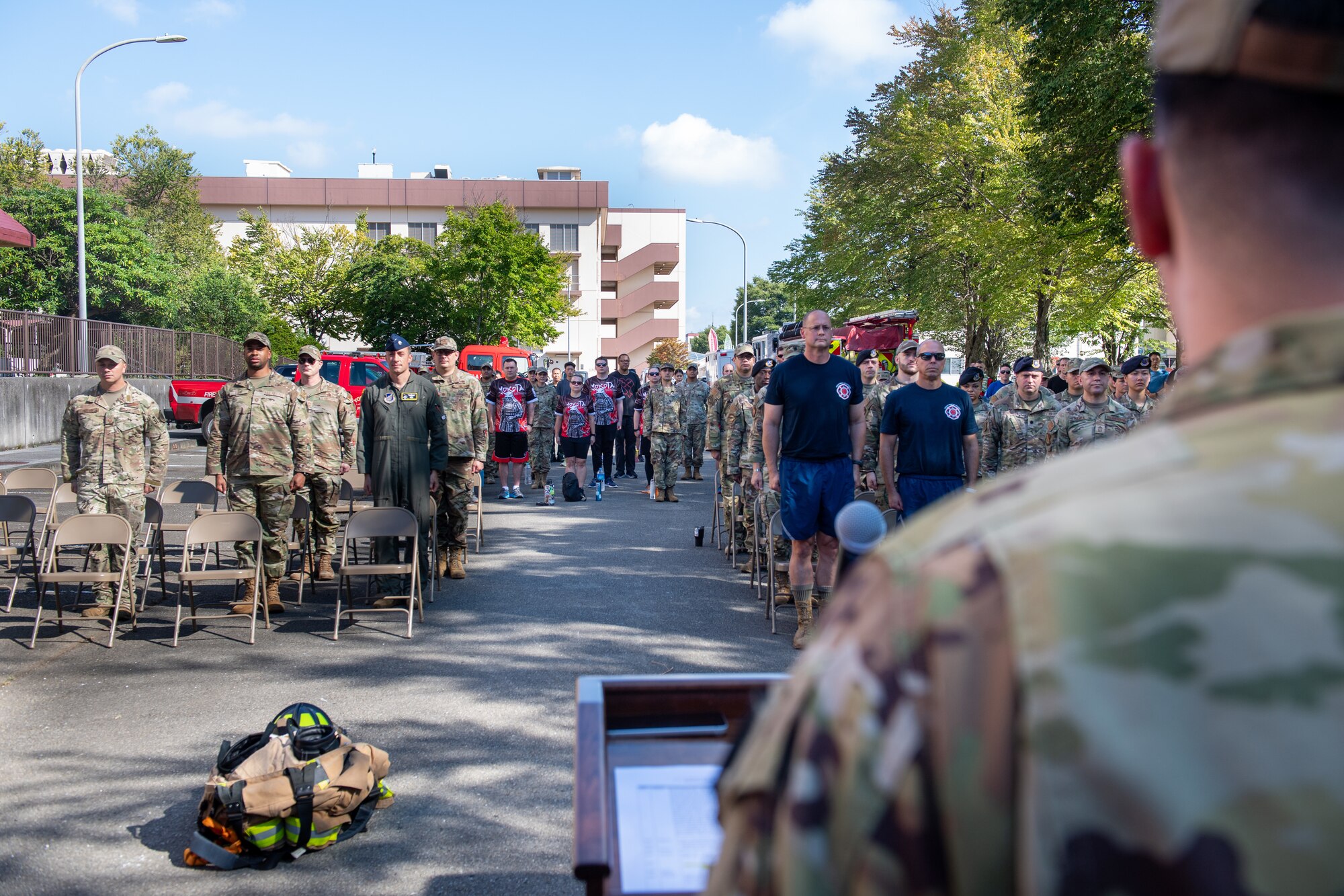 Military members are participants of the 9/11 Memorial Tower Run stand for the playing of the national anthem at the 9/11 memorial ceremony.