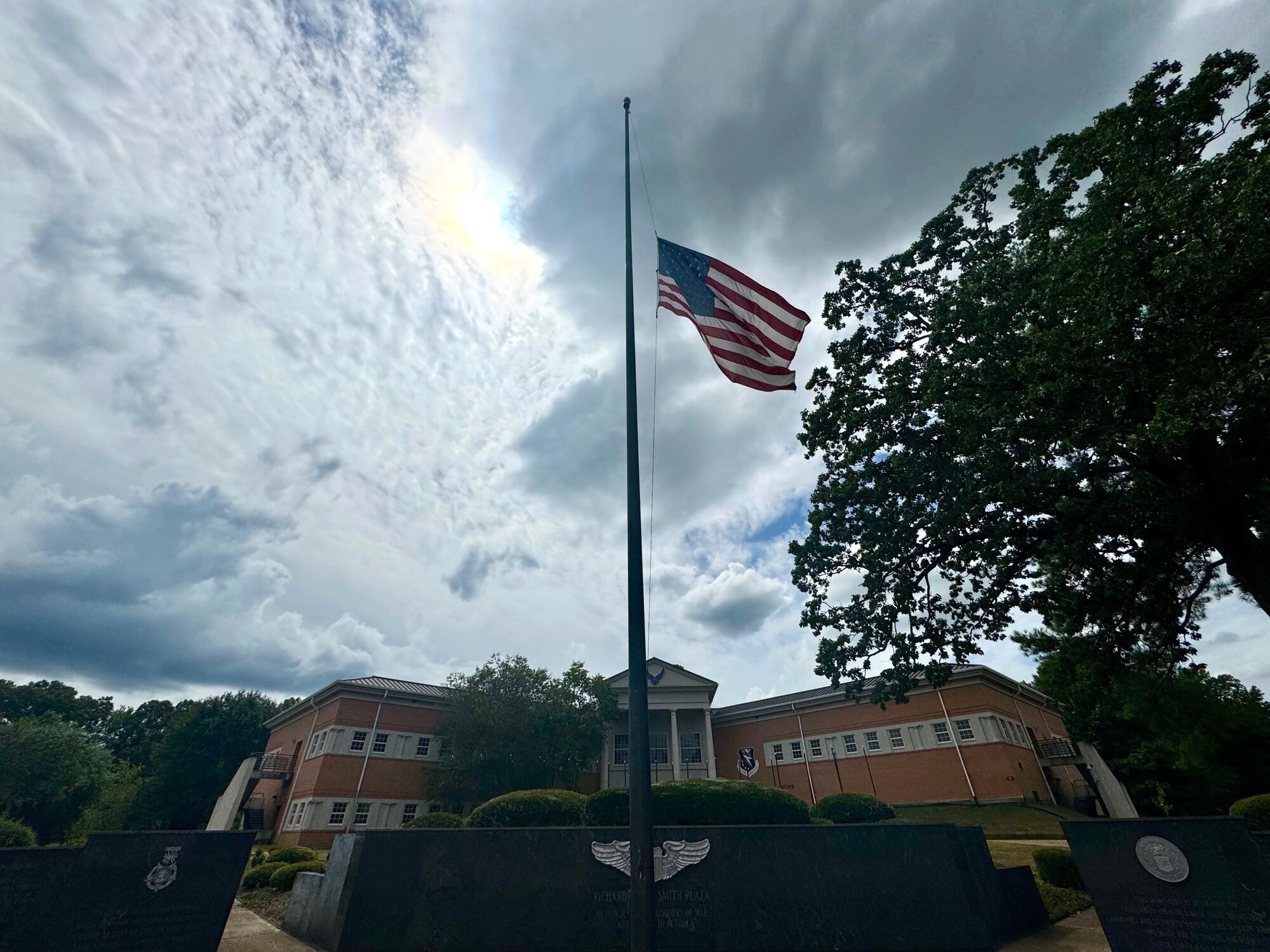 An American flag flies at half-mast outside of the Columbu Air Force Base Wing Building on September 11, 2024. Flying a flag at half-mast is a solemn practice used worldwide to signify a period of mourning or to mark a significant event.