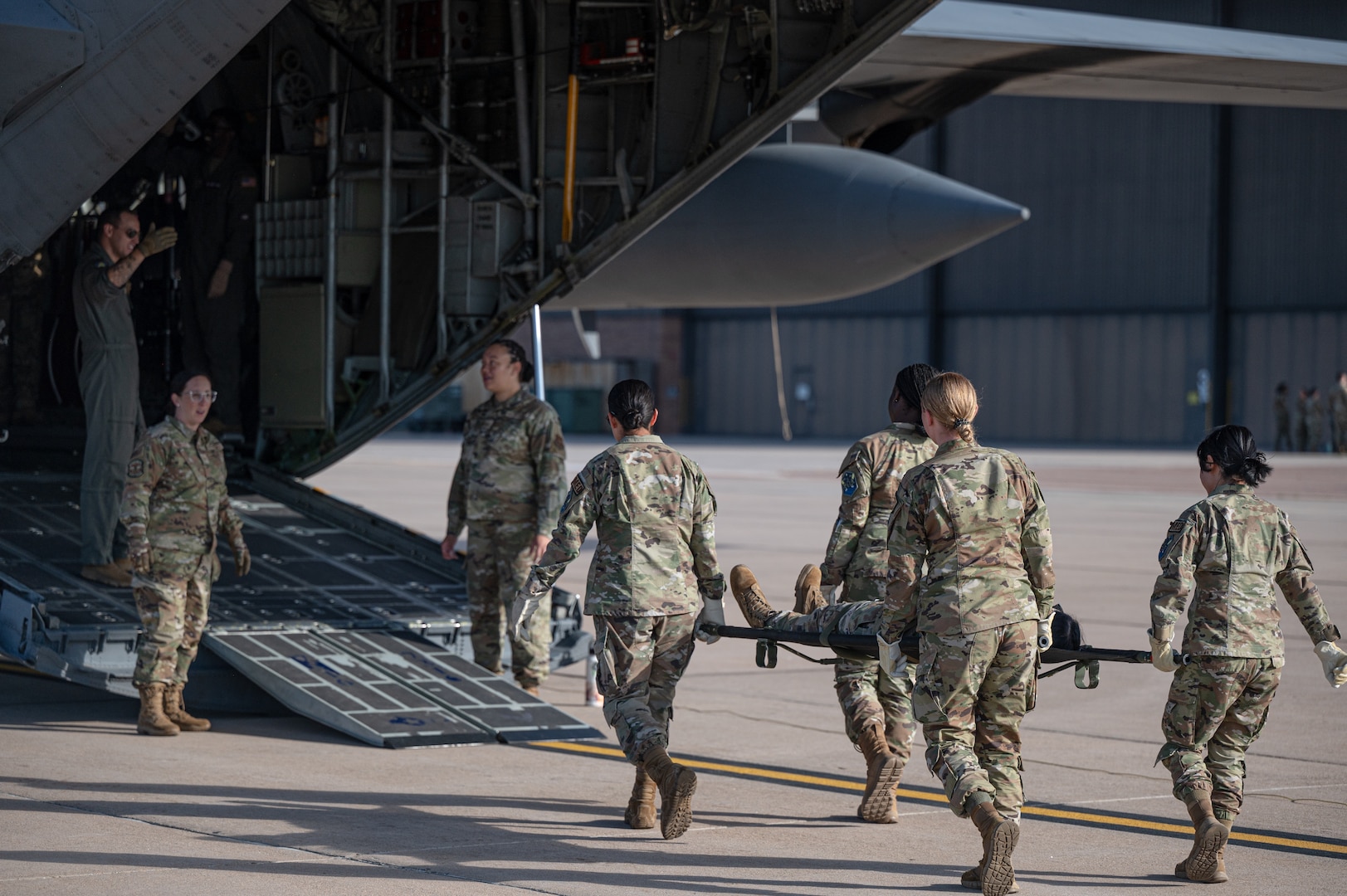 Airmen from the 21st Medical Group carry a medical stretcher to board a C-130 Hercules at Peterson Space Force Base, Colorado, Sept. 4, 2024. The 21st Medical Group and 21st Security Forces Squadron participated in an exercise with the 302nd Airlift Wing to practice patient on-loading and off-loading from an aircraft. (U.S. Space Force photo by 2nd Lt. Jacob Willoughby)