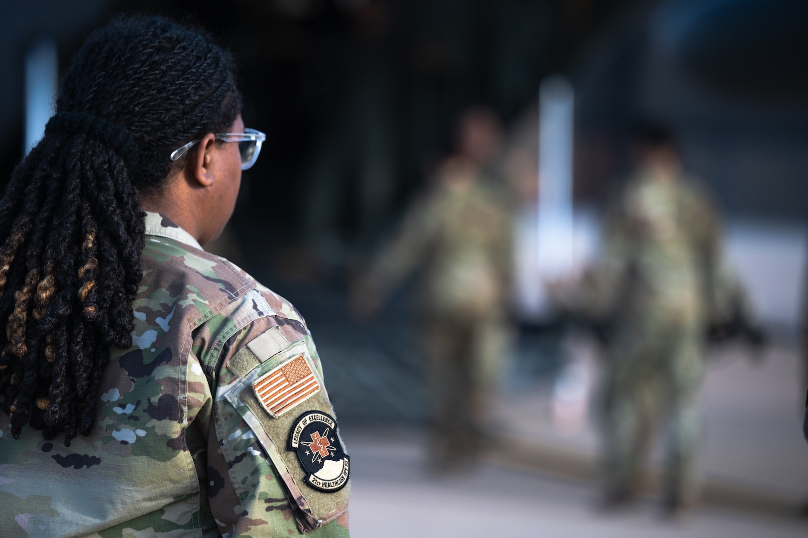 An Airman waits for her turn to practice patient on-loading and off-loading from an aircraft at Peterson Space Force Base, Colorado, Sept. 4, 2024. Medics from the 21st Medical Group participated in a joint exercise with the 21st Security Forces Squadron and the 302nd Airlift Wing, to practice deployed medic training. (U.S. Space Force photo by 1st Lt. Jacob Willoughby)