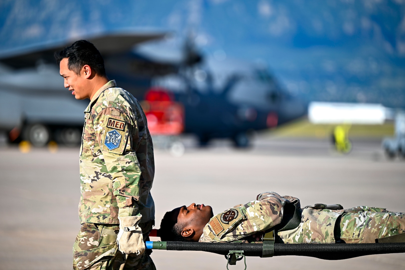 A 21st Medical Group Airman carries a 21st Dental Squadron Airman on a medical stretcher during a training at Peterson Space Force Base, Colorado, Sept. 4, 2024. Medic-X training provided Airmen with a refresher on deployment patient on-loading and off-loading from an aircraft. (U.S. Space Force photo by Staff Sgt. Natalie Rubenak)